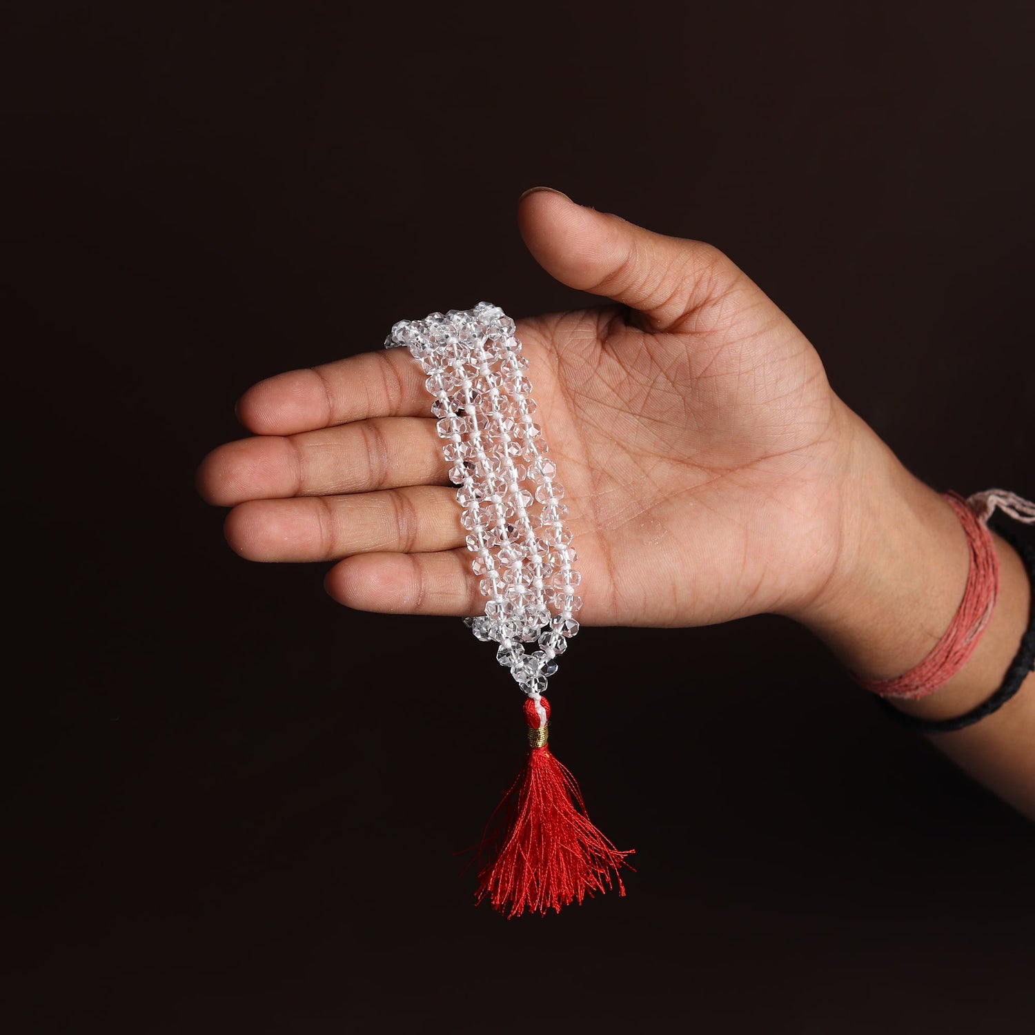 Sphatik Mala (Diamond Cut) with 108 Beads held in hand