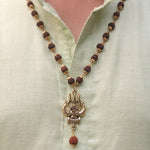 wearing a Rudraksha trishul necklace